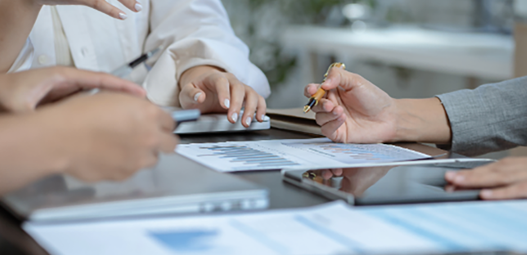 team meeting reviewing graphs and reports